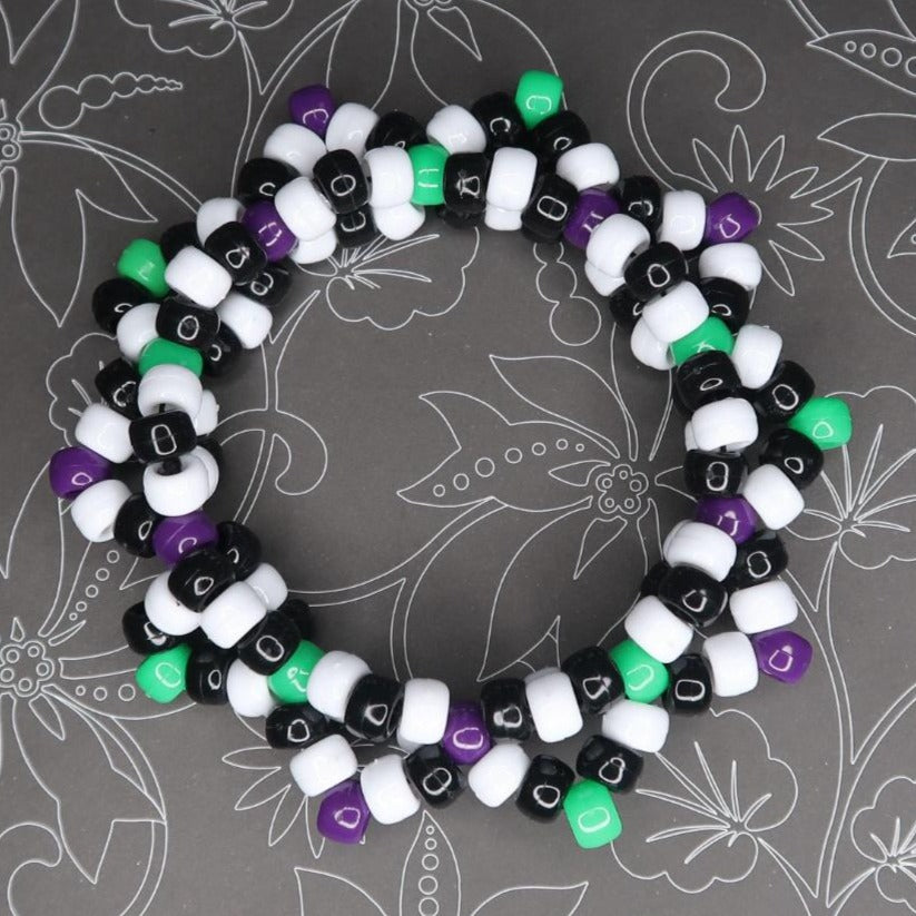 this kandi cuff definitely has spooky scary skeleton vibes with this haunted graveyard type of color scheme giving a Tim Burton aesthetic
