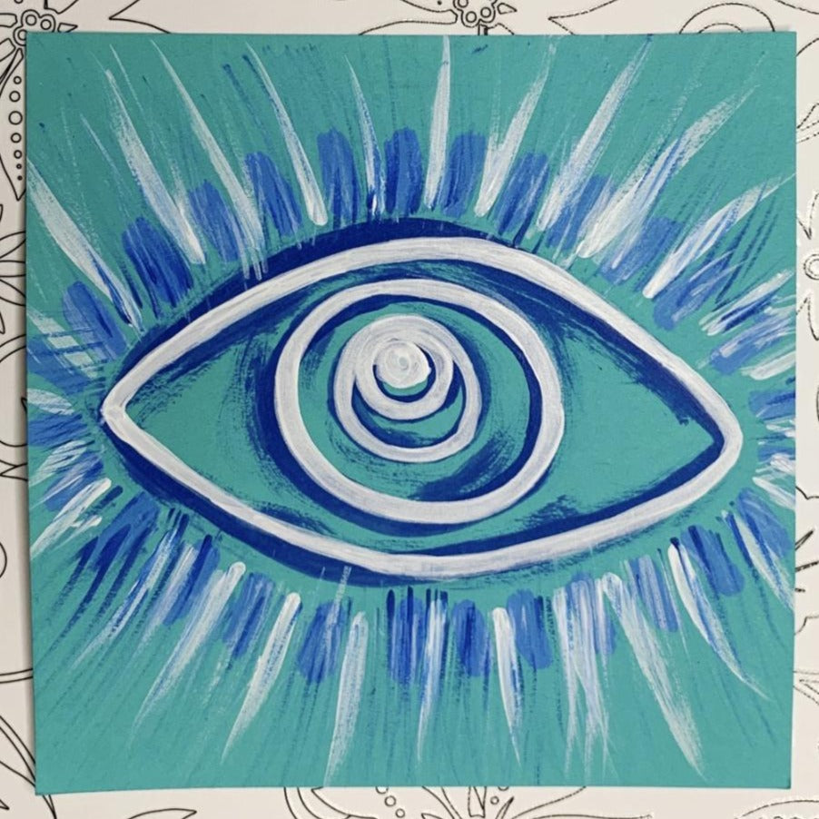 🧿 Evil Eye Protection original work of art done by Tori Arnold Art in dark blue & white acrylic paint on bright teal blue paper. there are rays extending off the eye to show the protection emanating from it protecting you from negative energy and evil spirits