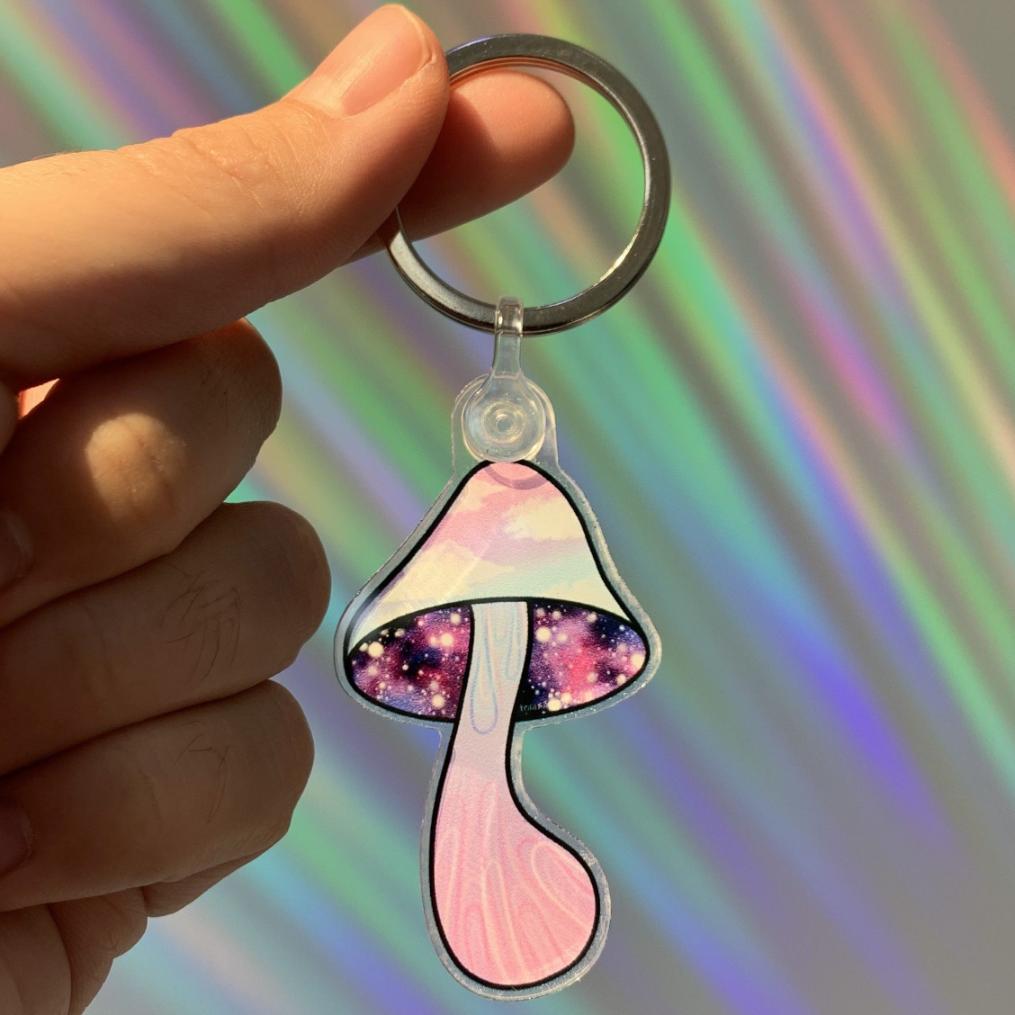 Shroom-scend Keychain with a pastel trippy mushroom design, with sunset clouds on the mush cap and a colorful galaxy underneath. design printed in full color. trippy-outerspace-galactic-shroom-scend-keychain-mushroom-cap-clouds